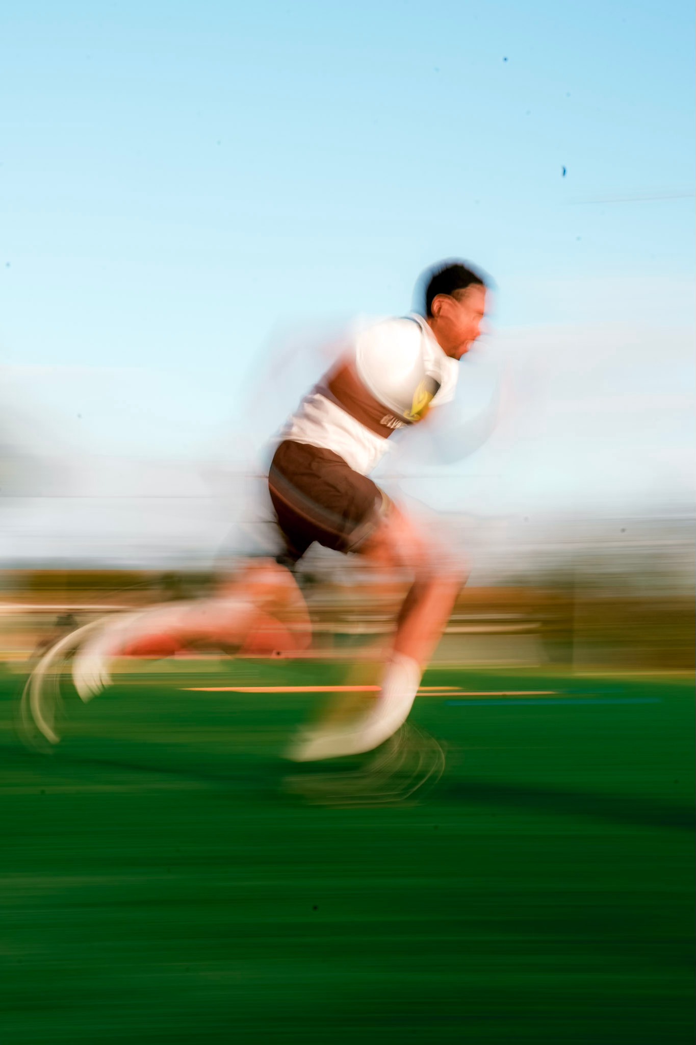 Sprinter accelerating out of the blocks under stadium lights